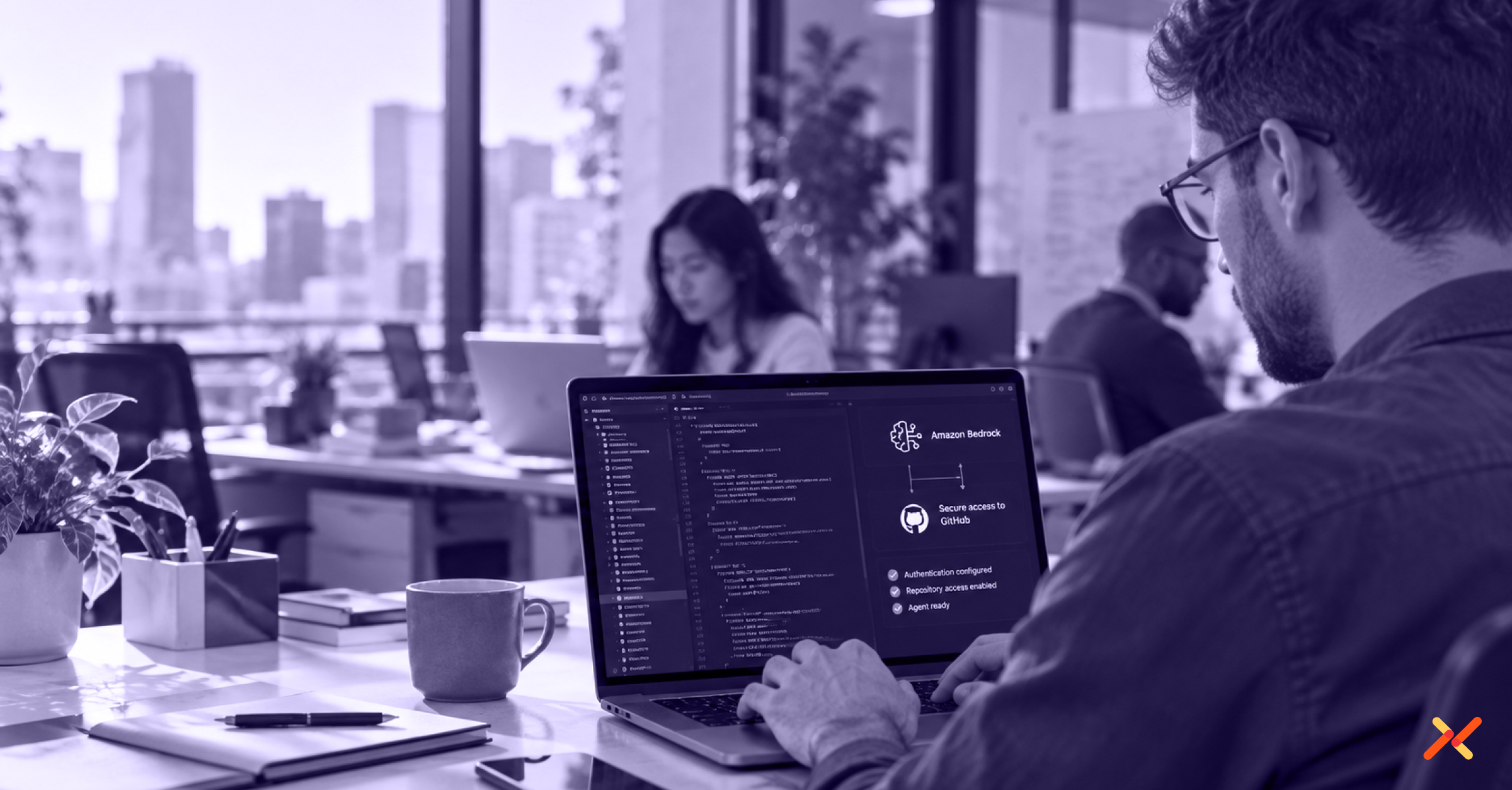 A professional in a modern office works at a laptop displaying Amazon Bedrock and GitHub access configuration, with coworkers blurred in the background.
