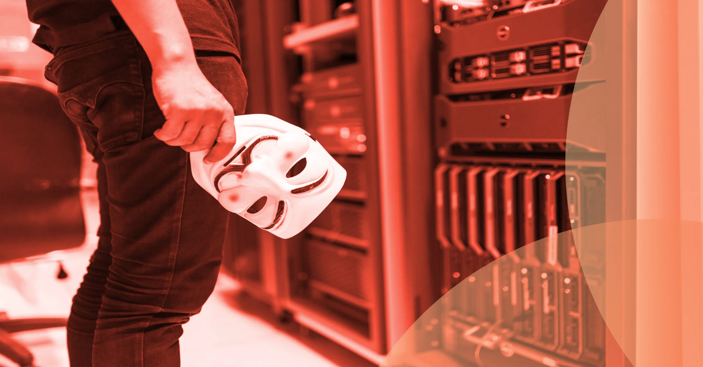 malicious hacker carrying anonymous mask looking at servers