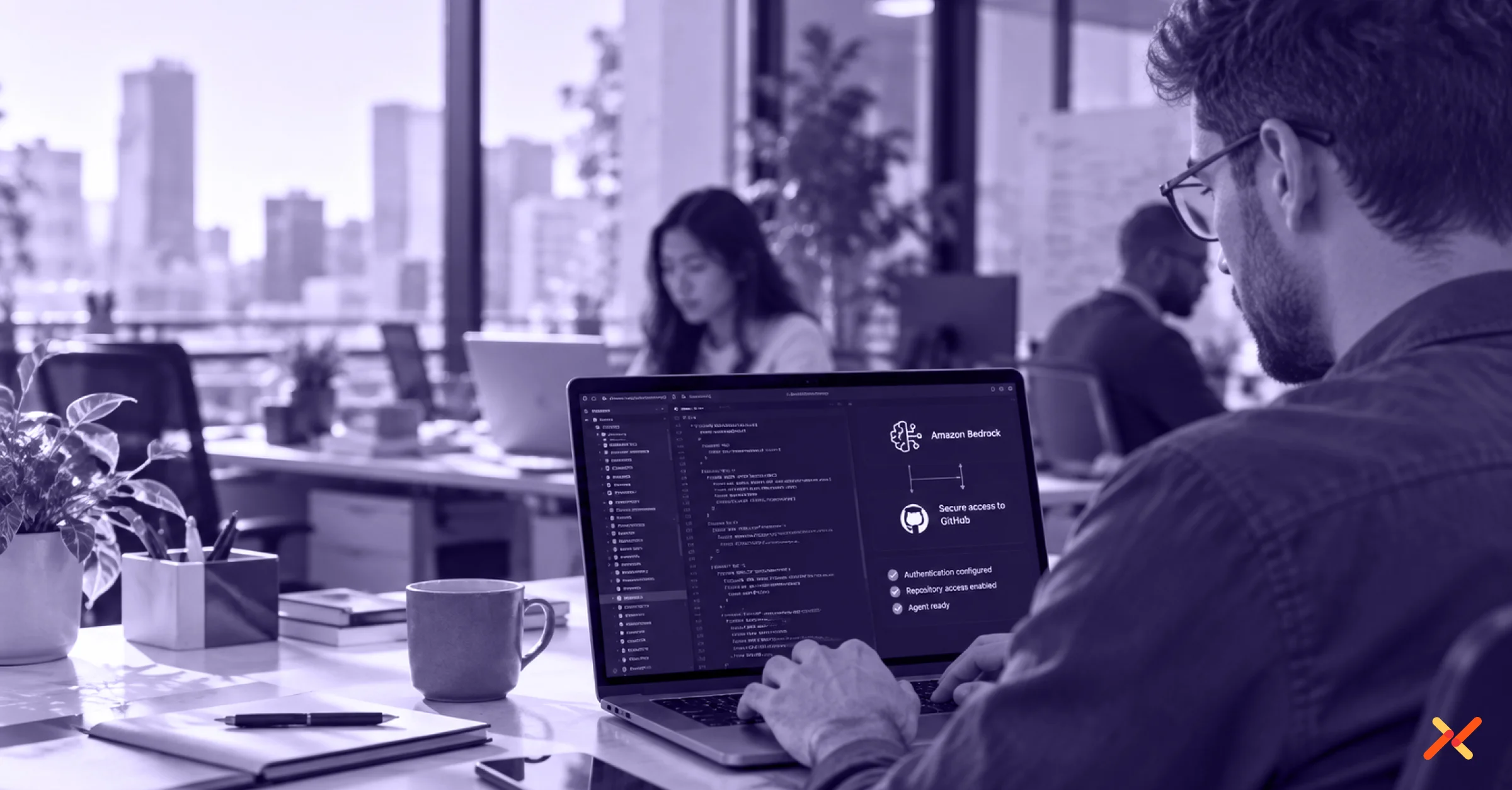 A professional in a modern office works at a laptop displaying Amazon Bedrock and GitHub access configuration, with coworkers blurred in the background.